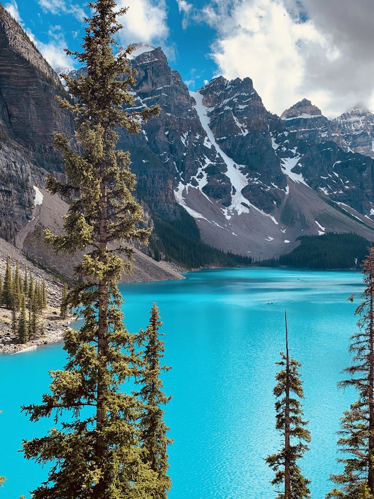 Experience the serene beauty of Moraine Lake with turquoise waters and majestic mountains.